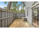Outdoor wooden deck with wood fence, sliding glass doors and AC unit at 8101 Interbay Blvd # A, Tampa, FL 33616