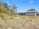 Backyard view with a glimpse of the screened patio and palm trees at 8240 Quail Rd, Seminole, FL 33777