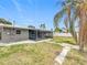 Spacious backyard featuring a patio and tropical landscaping at 8240 Quail Rd, Seminole, FL 33777