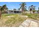 Spacious backyard with partial grass and unique landscape features at 8240 Quail Rd, Seminole, FL 33777