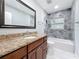 Bathroom features granite counters, tiled shower, updated fixtures, and soaking tub at 8240 Quail Rd, Seminole, FL 33777