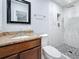 Modern bathroom features marble shower, granite countertop and updated fixtures at 8240 Quail Rd, Seminole, FL 33777