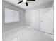 Bedroom with window, ceiling fan, and closet offers ample space and natural light at 8240 Quail Rd, Seminole, FL 33777