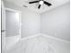Bright bedroom with ceiling fan features a closet and new paint at 8240 Quail Rd, Seminole, FL 33777