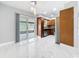Dining room with marble floors and access to outdoor patio and modern kitchen at 8240 Quail Rd, Seminole, FL 33777