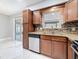 Kitchen features granite countertops, mosaic backsplash, and modern appliances at 8240 Quail Rd, Seminole, FL 33777