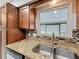Close-up shot of the kitchen sink, mosaic backsplash, and granite countertops at 8240 Quail Rd, Seminole, FL 33777