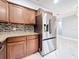 Kitchen featuring dark wood cabinets, granite countertops and stainless steel fridge at 8240 Quail Rd, Seminole, FL 33777