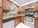 Kitchen features granite countertops, mosaic backsplash, and stainless steel appliances at 8240 Quail Rd, Seminole, FL 33777
