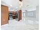 Open concept kitchen with stainless steel appliances and modern lighting at 8240 Quail Rd, Seminole, FL 33777