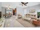 Bright living room featuring elegant marble floors, modern furnishings, and a ceiling fan at 8240 Quail Rd, Seminole, FL 33777