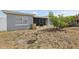 Backyard with small tree, birdbath and enclosed sunroom attached to gray home at 8330 Moulton Dr, Port Richey, FL 34668