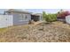 Backyard with small tree, birdbath and enclosed sunroom attached to gray home at 8330 Moulton Dr, Port Richey, FL 34668
