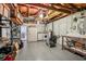 Unfinished basement with exposed wood beams and laundry area at 8330 Moulton Dr, Port Richey, FL 34668