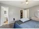 A cozy bedroom featuring light gray walls, a bed, closet, and adjoining bathroom at 8330 Moulton Dr, Port Richey, FL 34668