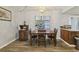 Cozy dining area with wood table and chairs, adjacent to the living room at 8330 Moulton Dr, Port Richey, FL 34668