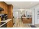 An open-concept space with laminate floors, a dining area, and a seamless flow from kitchen to living area at 8330 Moulton Dr, Port Richey, FL 34668
