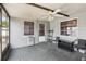 Enclosed sunroom with ceiling fan, windows and door to yard at 8330 Moulton Dr, Port Richey, FL 34668