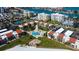 Gorgeous aerial view of the property and pool area with beautiful views of the blue bay in the background at 845 S Gulfview Blvd # 107, Clearwater Beach, FL 33767