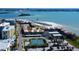Wonderful aerial view showcasing the property, pool, beach access, and the intercoastal waterway at 845 S Gulfview Blvd # 107, Clearwater Beach, FL 33767