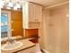 Bathroom includes a vanity with granite countertop, mirror, and built-in shelving by the tub at 845 S Gulfview Blvd # 107, Clearwater Beach, FL 33767