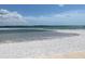 Scenic view of the white sandy beach and the calm blue water on a beautiful, sunny day at 845 S Gulfview Blvd # 107, Clearwater Beach, FL 33767