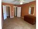Bedroom with tile flooring, closet, ceiling fan, and large dresser with decorative gold mirror at 845 S Gulfview Blvd # 107, Clearwater Beach, FL 33767