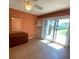 Bedroom features tile flooring, built-in shelves, and sliding glass door to a garden at 845 S Gulfview Blvd # 107, Clearwater Beach, FL 33767