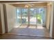 Bright room featuring a ceiling fan, built-in cabinets, and sliding glass doors to outside at 845 S Gulfview Blvd # 107, Clearwater Beach, FL 33767