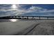 Picturesque view of the bridge over the water, with the sandy beach in the foreground at 845 S Gulfview Blvd # 107, Clearwater Beach, FL 33767