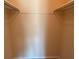 Walk-in closet with hanging rods and neutral-colored walls at 845 S Gulfview Blvd # 107, Clearwater Beach, FL 33767