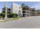 Beautiful condominium exterior, palm trees, well-maintained landscaping, and ample parking at 845 S Gulfview Blvd # 107, Clearwater Beach, FL 33767