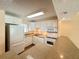 Modern kitchen with white appliances, granite countertops and ample cabinet space at 845 S Gulfview Blvd # 107, Clearwater Beach, FL 33767