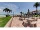 Outdoor patio with picnic tables, grill, and a view of the intercoastal and American flag at 845 S Gulfview Blvd # 107, Clearwater Beach, FL 33767