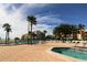 Community pool area with hot tub, plenty of lounging, and lush tropical landscaping at 845 S Gulfview Blvd # 107, Clearwater Beach, FL 33767