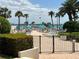 Community pool deck with chairs, sun umbrellas and a gate to the intercoastal at 845 S Gulfview Blvd # 107, Clearwater Beach, FL 33767