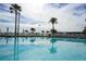 Sparkling community pool with lounge chairs surrounded by lush tropical landscaping at 845 S Gulfview Blvd # 107, Clearwater Beach, FL 33767