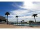 Community swimming pool with beach access surrounded by palm trees and lush landscaping at 845 S Gulfview Blvd # 107, Clearwater Beach, FL 33767