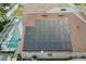 Aerial view of house with solar panels, screened-in pool, and mature landscaping at 8915 Hannigan Ct, Tampa, FL 33626