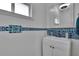 Charming half bathroom with colorful mosaic tile accents and a decorative mirror at 8915 Hannigan Ct, Tampa, FL 33626