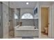 Elegant bathroom with a soaking tub, glass-enclosed shower, and decorative tile work at 8915 Hannigan Ct, Tampa, FL 33626