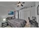 Comfortable bedroom featuring a bed, a ceiling fan, and a desk area with a computer at 8915 Hannigan Ct, Tampa, FL 33626