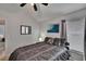 Neutral toned bedroom featuring a bed, a ceiling fan, and a view of the window at 8915 Hannigan Ct, Tampa, FL 33626