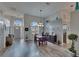 Inviting dining room with laminate flooring, stylish furniture, modern lighting, and views from expansive windows at 8915 Hannigan Ct, Tampa, FL 33626