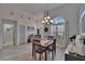 Bright dining room with hardwood table, decorative lighting, large window, and neutral-toned decor at 8915 Hannigan Ct, Tampa, FL 33626