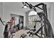 Home gym features multiple exercise machines, natural light, and is equipped for a comprehensive workout at 8915 Hannigan Ct, Tampa, FL 33626