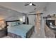 Comfortable main bedroom with barn door access to en-suite bathroom and stylish decor at 8915 Hannigan Ct, Tampa, FL 33626