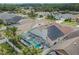 Screened-in pool, lush landscaping, and solar panels seen from an aerial view at 8915 Hannigan Ct, Tampa, FL 33626