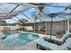 Inviting screened-in pool area with comfortable lounge chairs, umbrella, and outdoor space at 8915 Hannigan Ct, Tampa, FL 33626