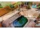 Aerial view of a secluded backyard with a uniquely-shaped spa and stone accents at 919 Sandpiper S Way, St Petersburg, FL 33707